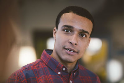 Smiling businessman looking away at office