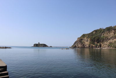 Scenic view of sea against clear blue sky