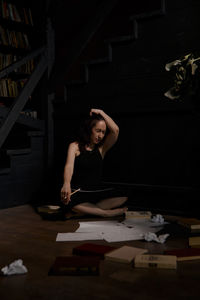 Portrait of young woman sitting on table