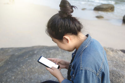 Side view of man using mobile phone