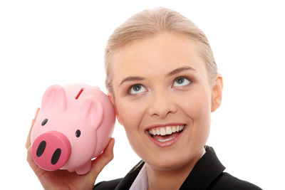 Portrait of smiling young woman against white background