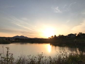 Scenic view of lake against sky during sunset