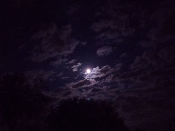 Low angle view of silhouette moon against sky at night