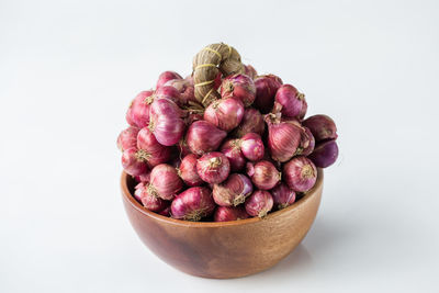 Close-up of strawberries in bowl against white background