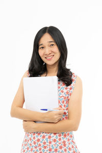 Portrait of a smiling young woman against white background