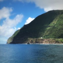 Scenic view of sea and mountains against sky