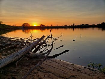 Scenic view of lake against sky during sunset