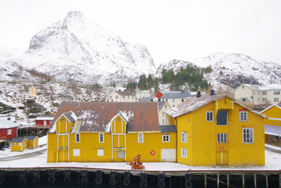 Residential buildings against sky during winter