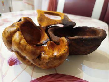 Close-up of hand holding bread on table