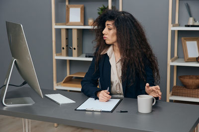 Businesswoman working at at desk in office