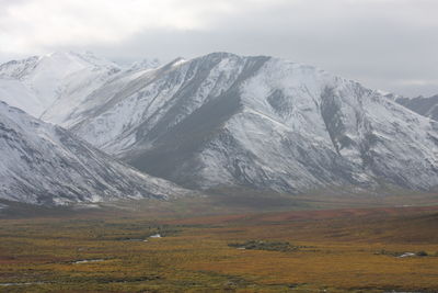 Scenic view of snowcapped mountains against sky