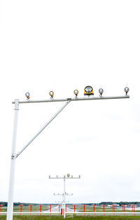 Low angle view of street lights against clear sky