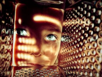 Close-up of girl seen through grater