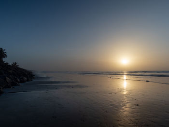 Scenic view of sea against clear sky during sunset