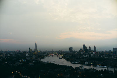 View of cityscape against cloudy sky