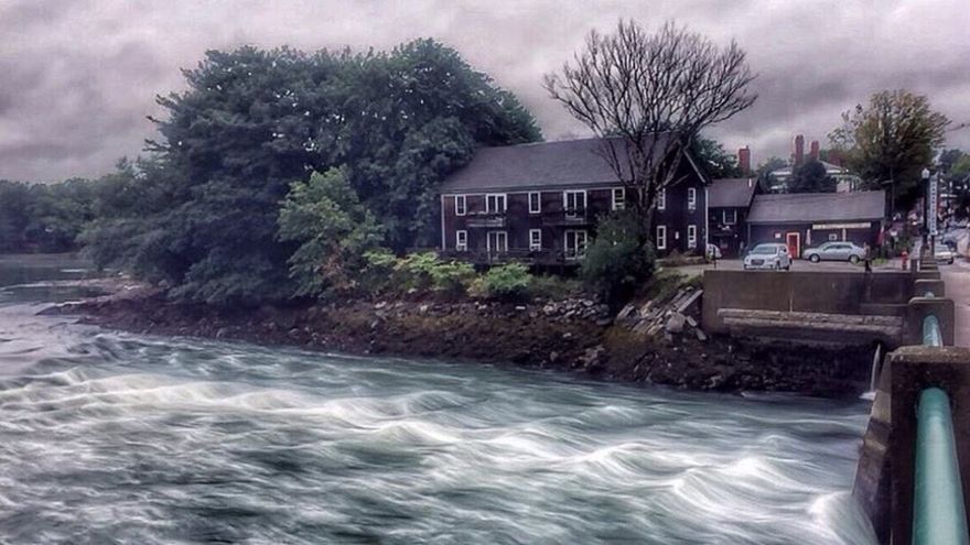 RIVER WITH HOUSES IN FOREGROUND