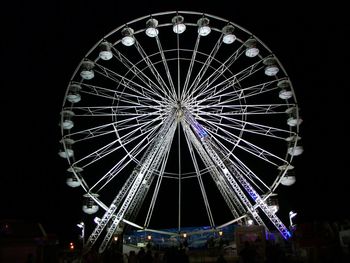 Low angle view of ferris wheel against sky at night