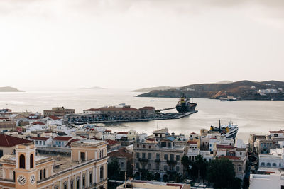 High angle view of buildings by sea against clear sky