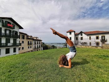 Full length of man on field by building against sky