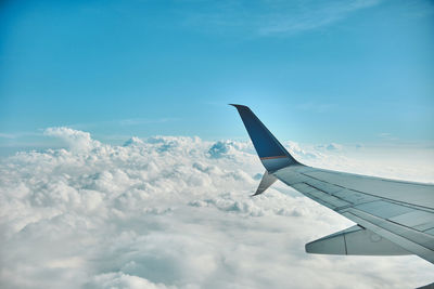 Cropped image of airplane wing against sky