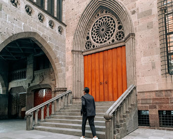 Full length rear view of man walking in building