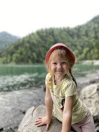 Portrait of smiling young woman on land