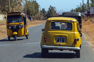 View of yellow car on road