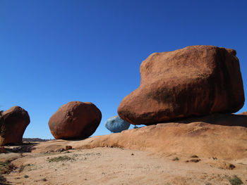 Rocks on rock formation against sky