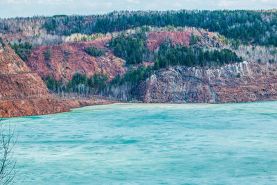 Frozen lake against rocky mountain