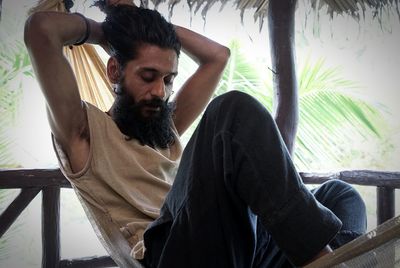Close-up of young man sitting outdoors