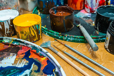 Artist's brushes and bright colors in an art workshop