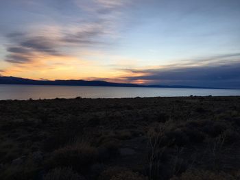 Scenic shot of calm countryside lake at sunset