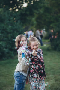 Girl and women standing in park