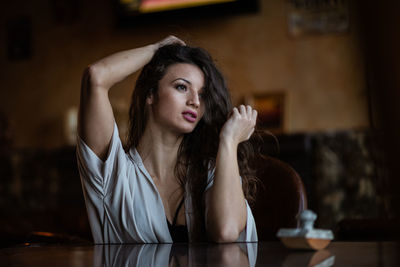 Portrait of young woman at home