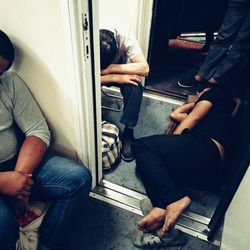 Midsection of man sitting in train