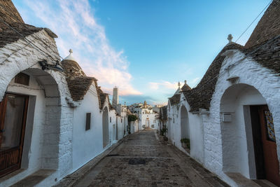Footpath amidst buildings in city