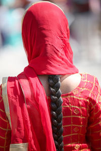 Rear view of man with red umbrella