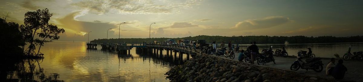 Scenic view of river against sky at sunset