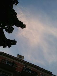 Low angle view of building against cloudy sky