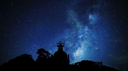 Low angle view of silhouette statue against sky at night