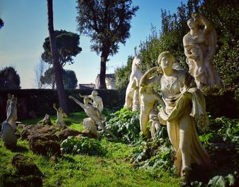 Statue against trees