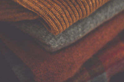 Full frame shot of sweaters stacked at home