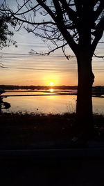 Scenic view of lake against orange sky