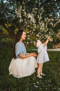 Portrait of smiling young woman sitting on field