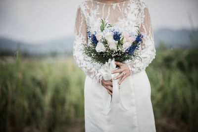 Close-up of woman holding white flower