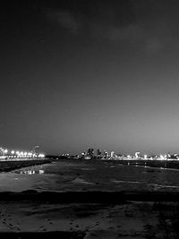 Scenic view of sea against clear sky at night