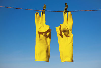 Low angle view of clothes hanging against sky