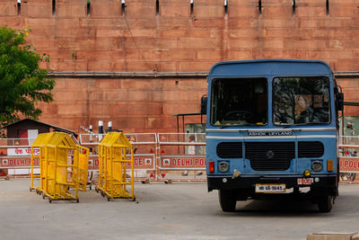 Vehicles on street against building in city