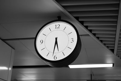 Low angle view of clock on wall