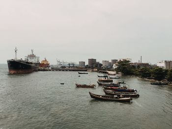 Ship in sea against sky in city